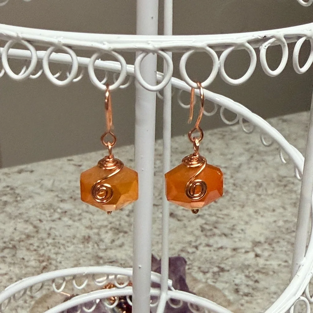 Copper Wire-Wrapped Orange Faceted Hexagon Earrings.